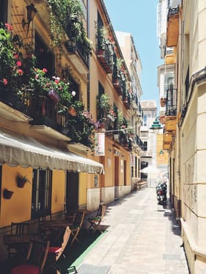 ESAGP Malaga empty seats and tables in between buildings during daytime Jonas Hoss.jpg Photo